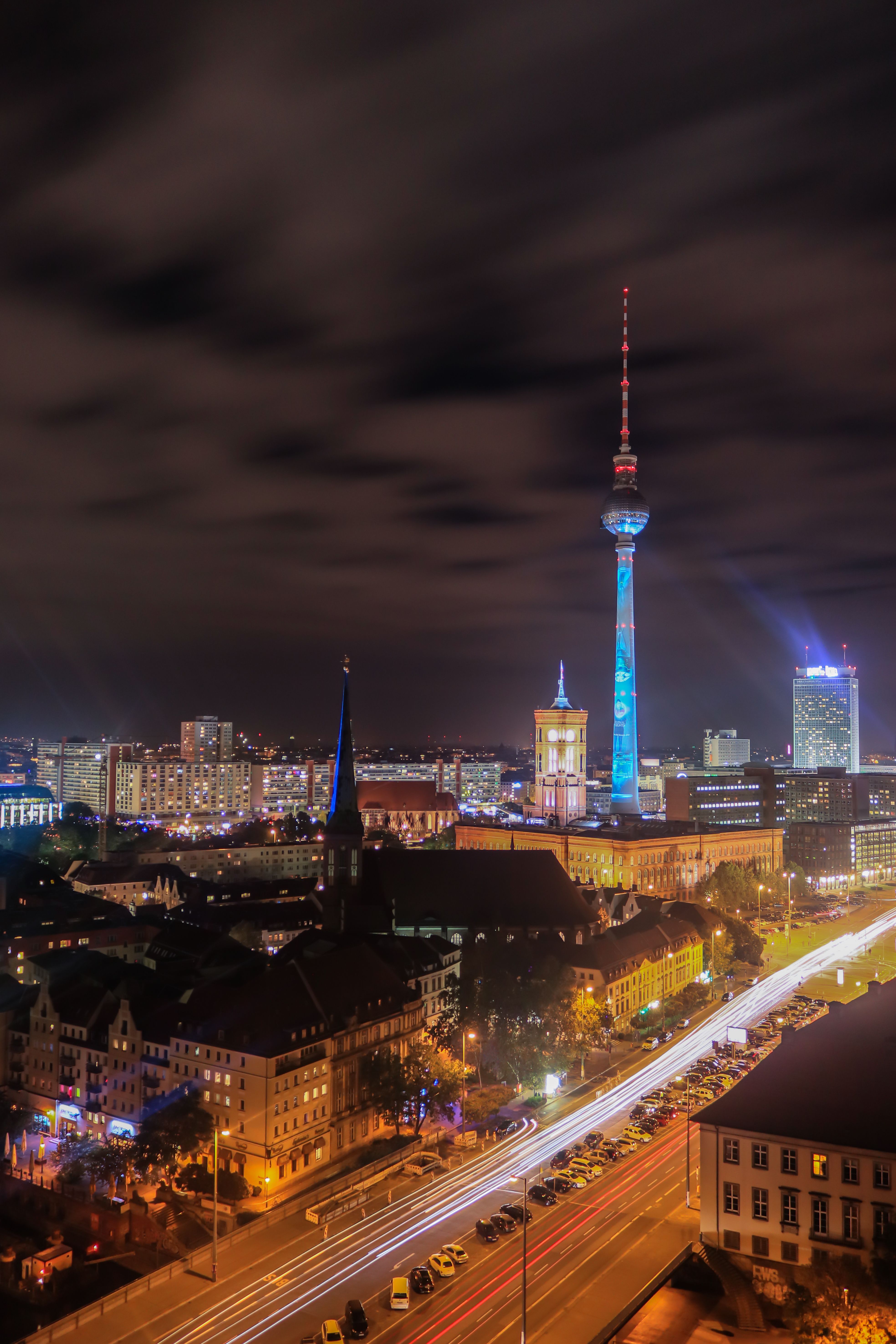 Long exposure night shot of Berlin's skyline featuring the iconic Fernsehturm tower
