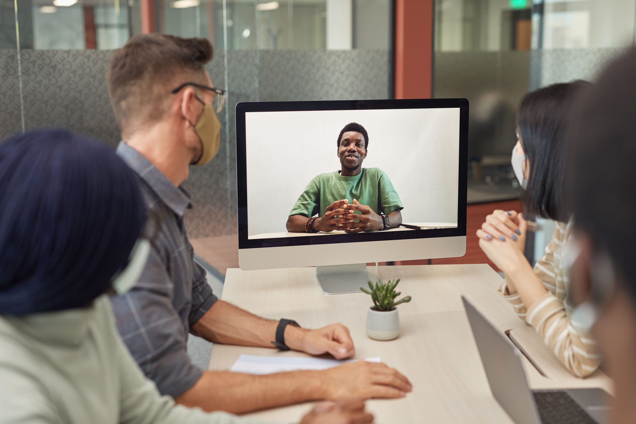 Diverse remote team taking part in a video conference to coordinate cross-border work