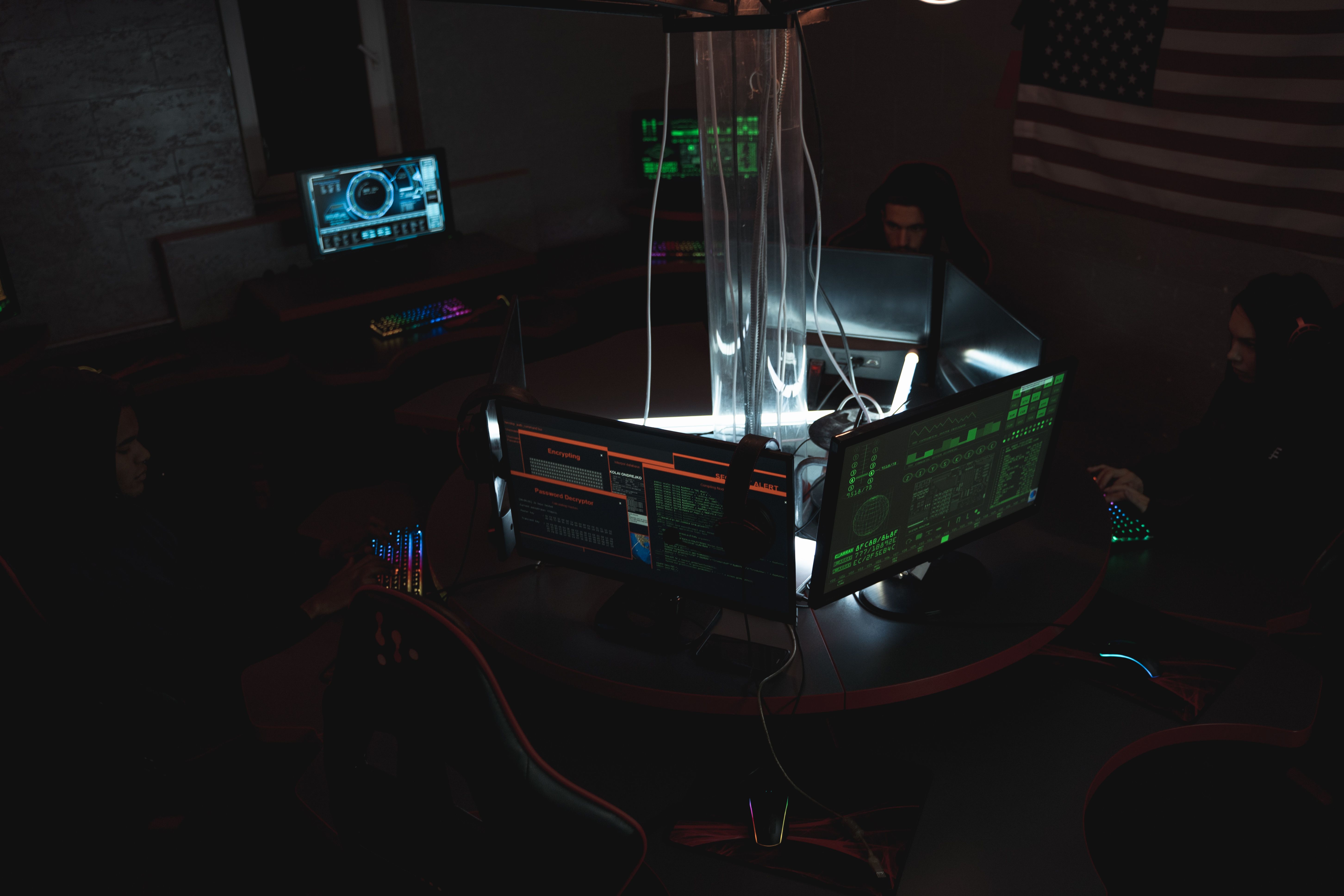 Cybersecurity team working together at computer stations, representing security operations monitoring.