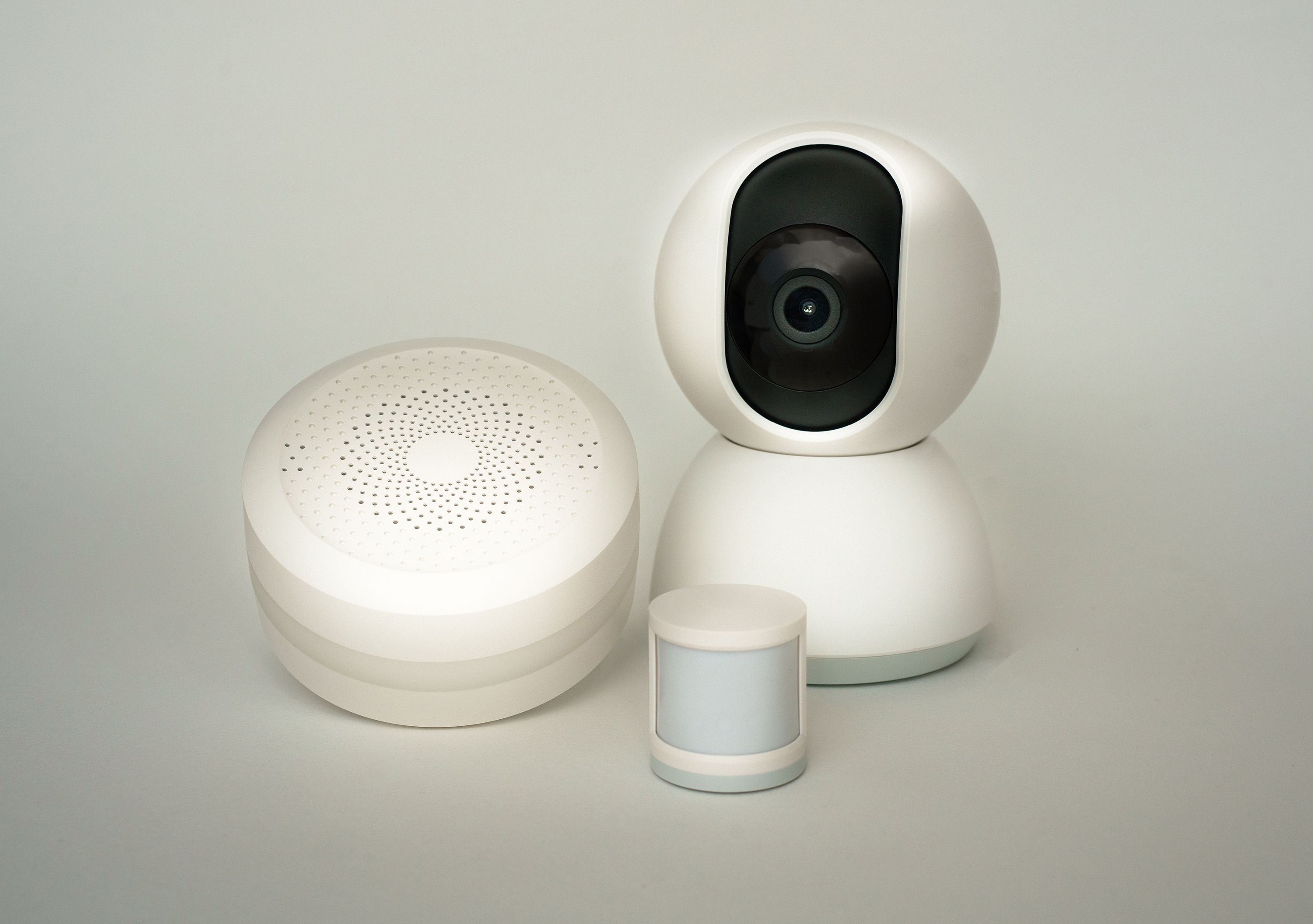 Modern smart home camera and sensors arranged together for an electronic security system.